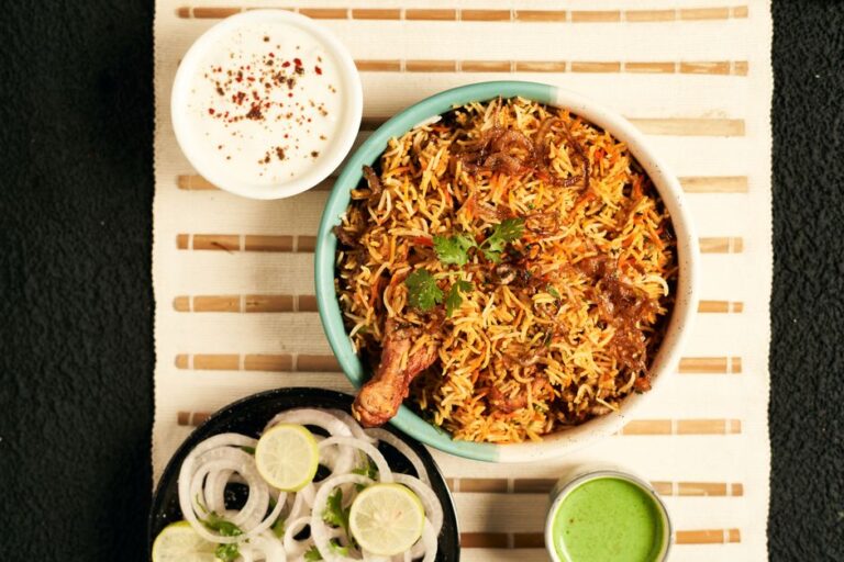 A plate of chicken biryani with raita