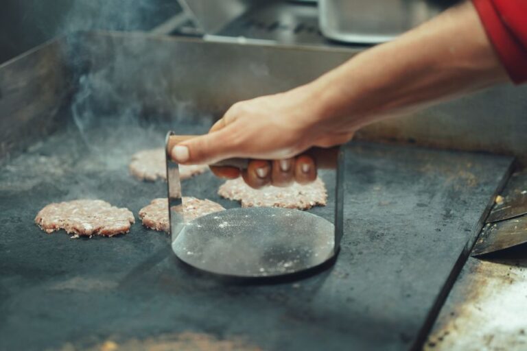 A smash burger patty on a griddle
