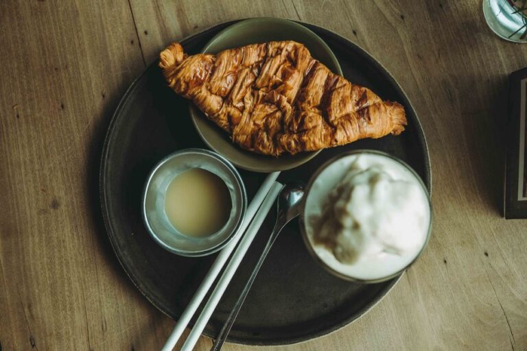 A croissant beside coffee